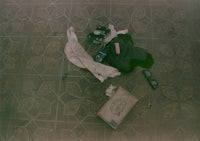 a camera and a cell phone on a tiled floor