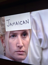 a woman's head is covered with a sign that says jamaican