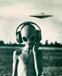 a boy wearing headphones with a ufo flying over his head