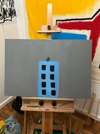 a painting of a building on an easel