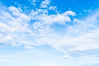 a blue sky with white clouds in the background