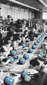 a group of people working in a factory with globes on their desks